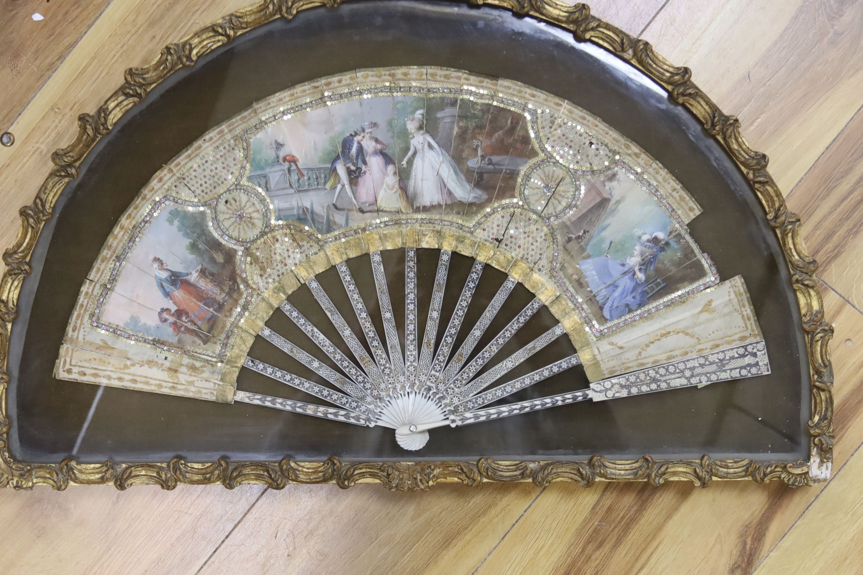 TO BE COLLECTED BY VENDOR Two late 18th/19th century French gesso framed fans with mother of pearl inlaid ivory sticks and guards with hand painted cartouche of classical figures and landscape on the fan leaves, length o